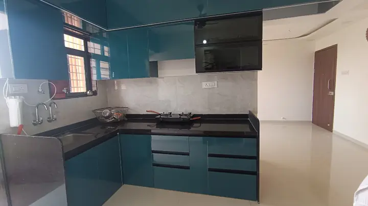 Peacock teal gloss modular kitchen at handover – VS Interiors, Wagholi