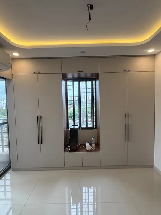 Bedroom wardrobe wall around the window with cove-lit ceiling – VS Interiors, Wagholi