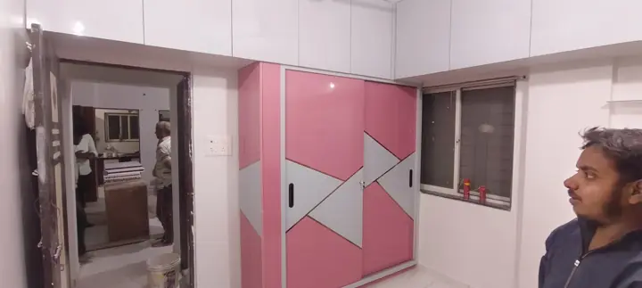 Pink sliding wardrobe with geometric shutters – VS Interiors, Wagholi